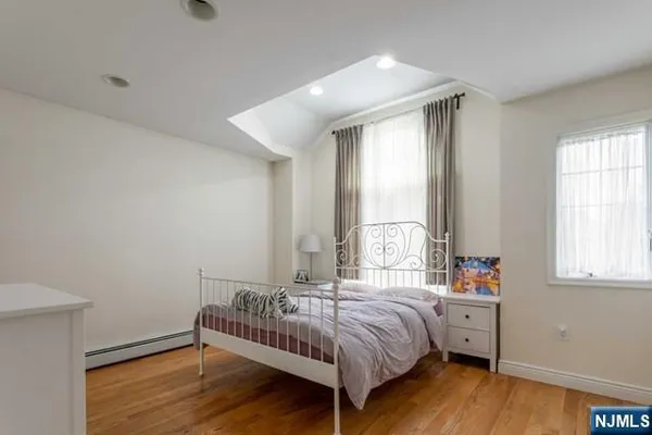 a spacious bedroom with a bed and a window
