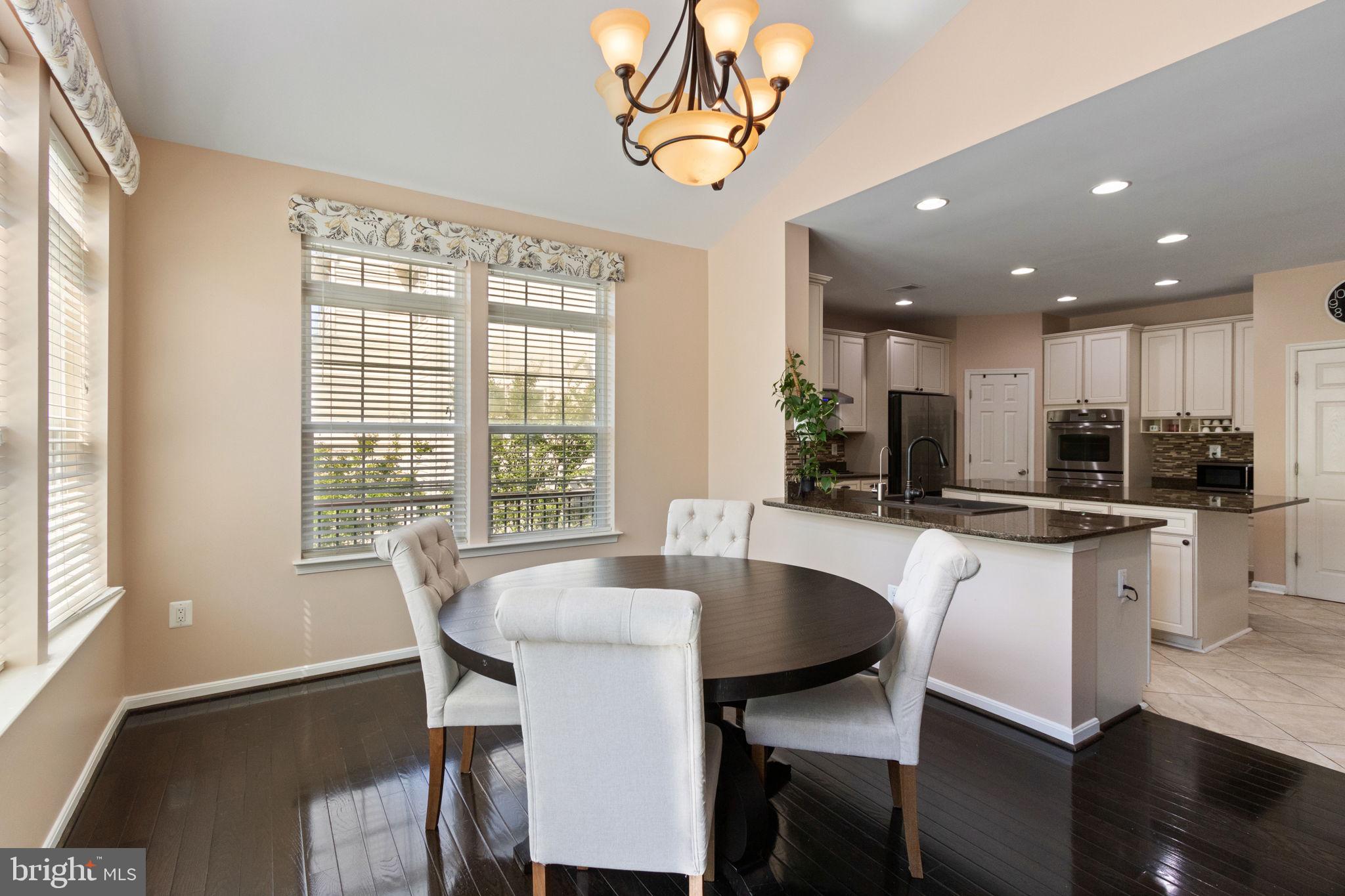 18 Dewitt Road Stafford, VA 22554 - Photo 27 of 73 a kitchen with a dining table chairs and white cabinets