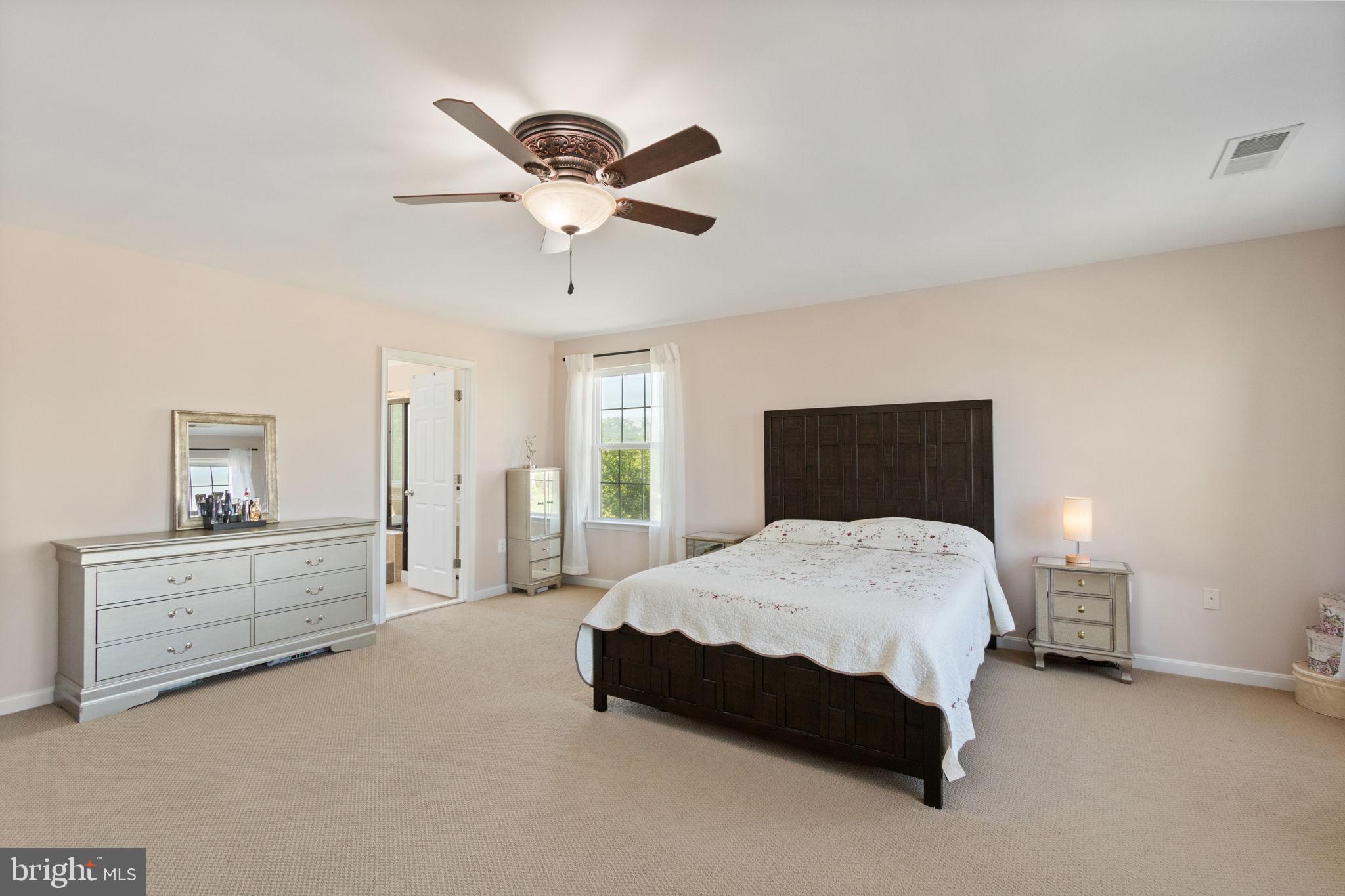 18 Dewitt Road Stafford, VA 22554 - Photo 43 of 73 a spacious bedroom with a bed and a chandelier