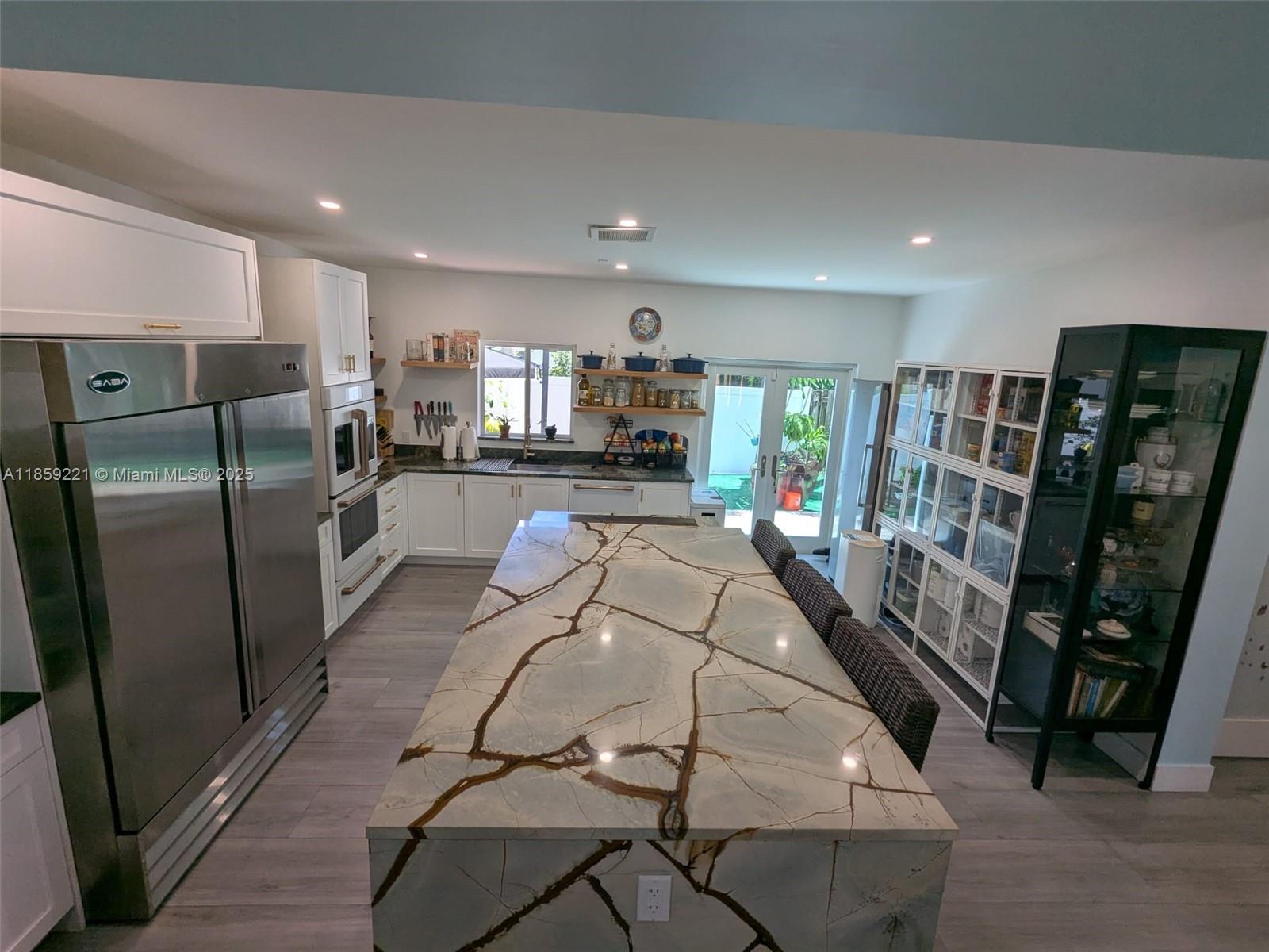 524 Northeast 27th Drive Wilton Manors, FL 33334 - Photo 12 of 95 Striking quartz waterfall island with generous breakfast seating, perfect for elegant mornings