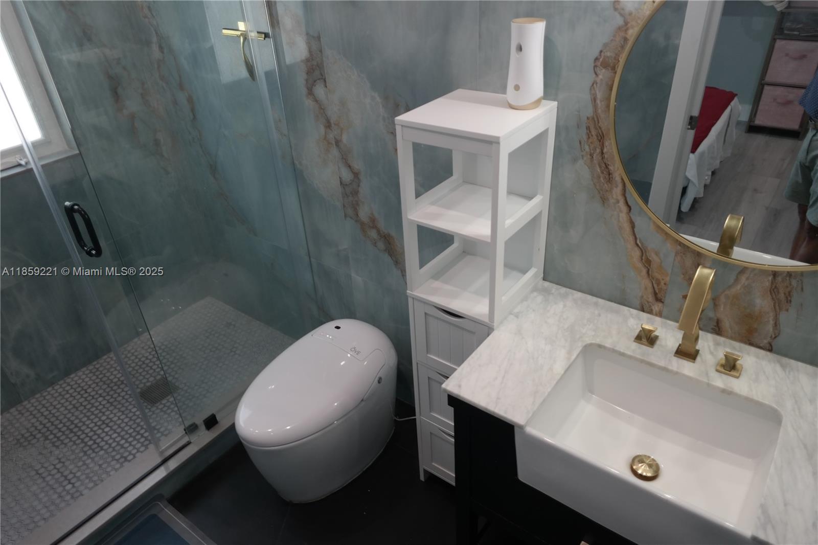 524 Northeast 27th Drive Wilton Manors, FL 33334 - Photo 29 of 95 a bathroom with a sink mirror and toilet