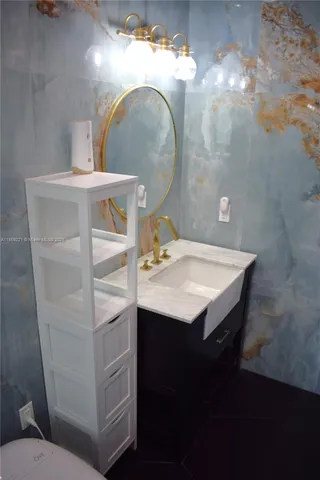 a view of a patio with table and chairs under an umbrella with palm trees