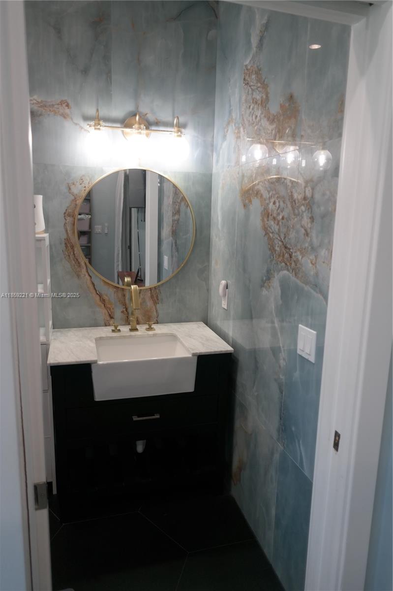 524 Northeast 27th Drive Wilton Manors, FL 33334 - Photo 33 of 95 The bathroom design features exquisite design in complementary tones that come together like a beautiful visual composition.