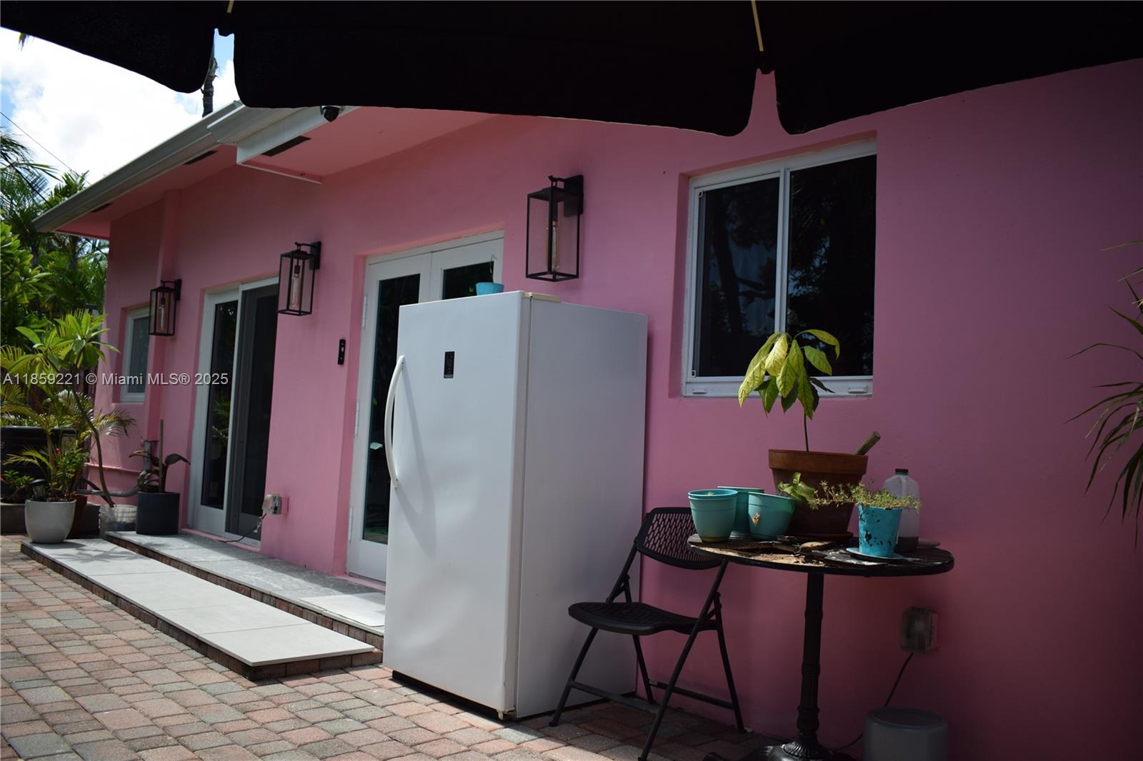 524 Northeast 27th Drive Wilton Manors, FL 33334 - Photo 42 of 95 a front view of a house with an outdoor seating space