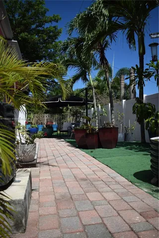 a living room with furniture and a view of kitchen