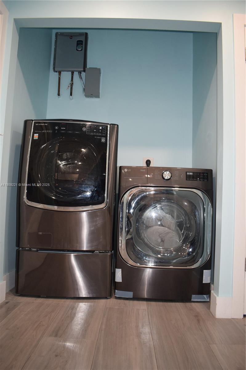 524 Northeast 27th Drive Wilton Manors, FL 33334 - Photo 49 of 95 Modern and functional laundry area paired with a state-of-the-art water heater for everyday comfort and efficiency