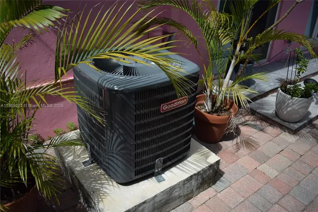 a living room with furniture a flat screen tv and kitchen view