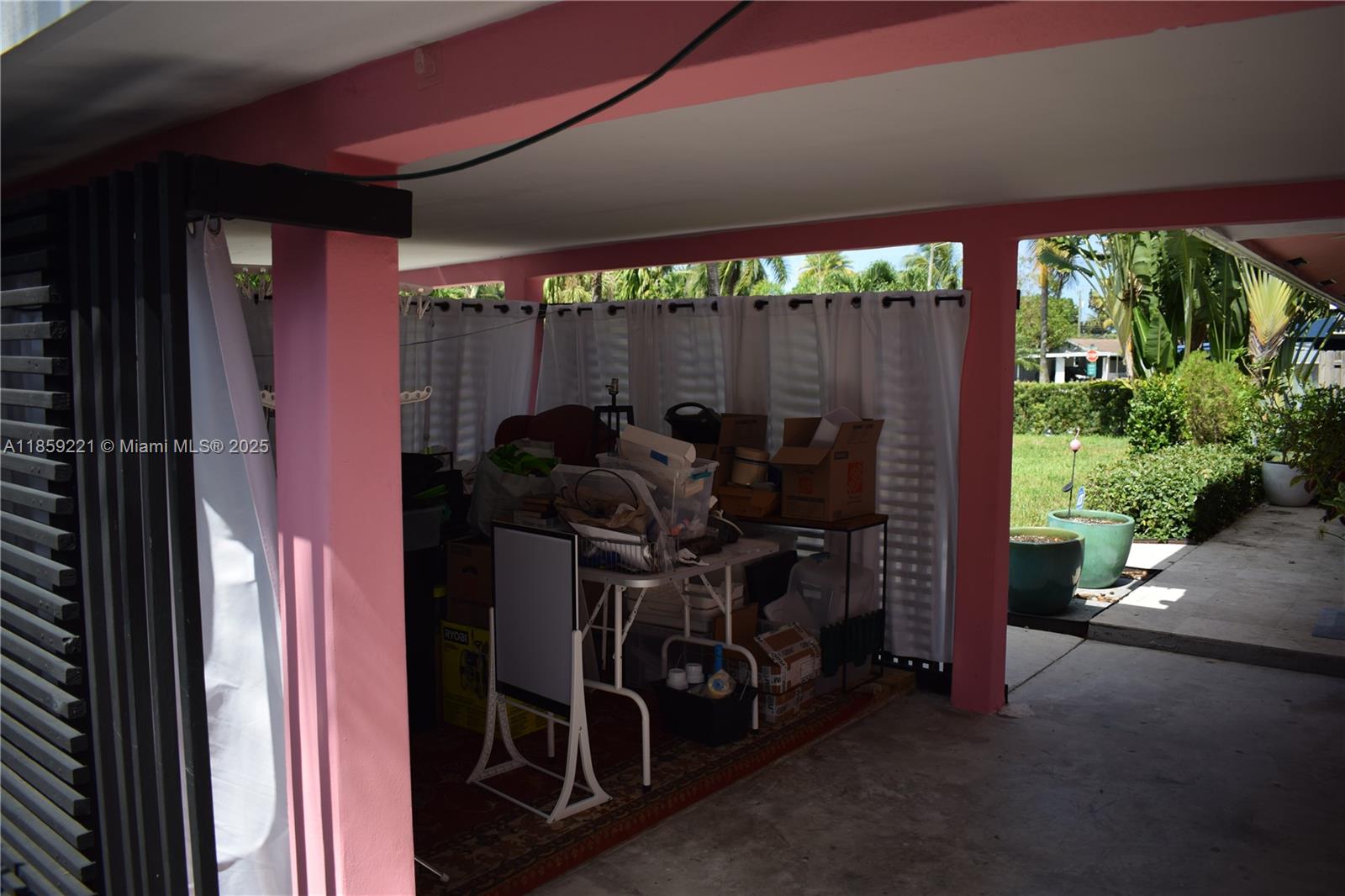 524 Northeast 27th Drive Wilton Manors, FL 33334 - Photo 58 of 95 Enjoy the versatility of a covered carport transformed into a stylish multi-use area, ideal for creative work, fitness, or bar area.