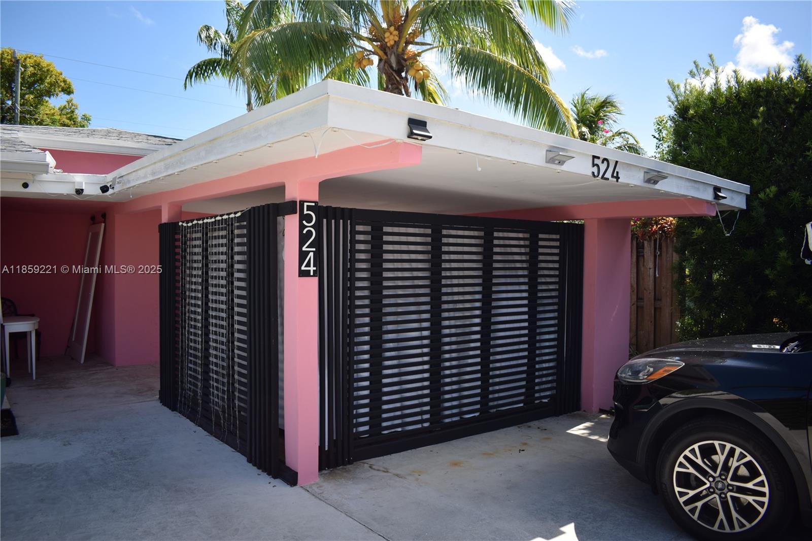 524 Northeast 27th Drive Wilton Manors, FL 33334 - Photo 59 of 95 a front view of a house with a garage
