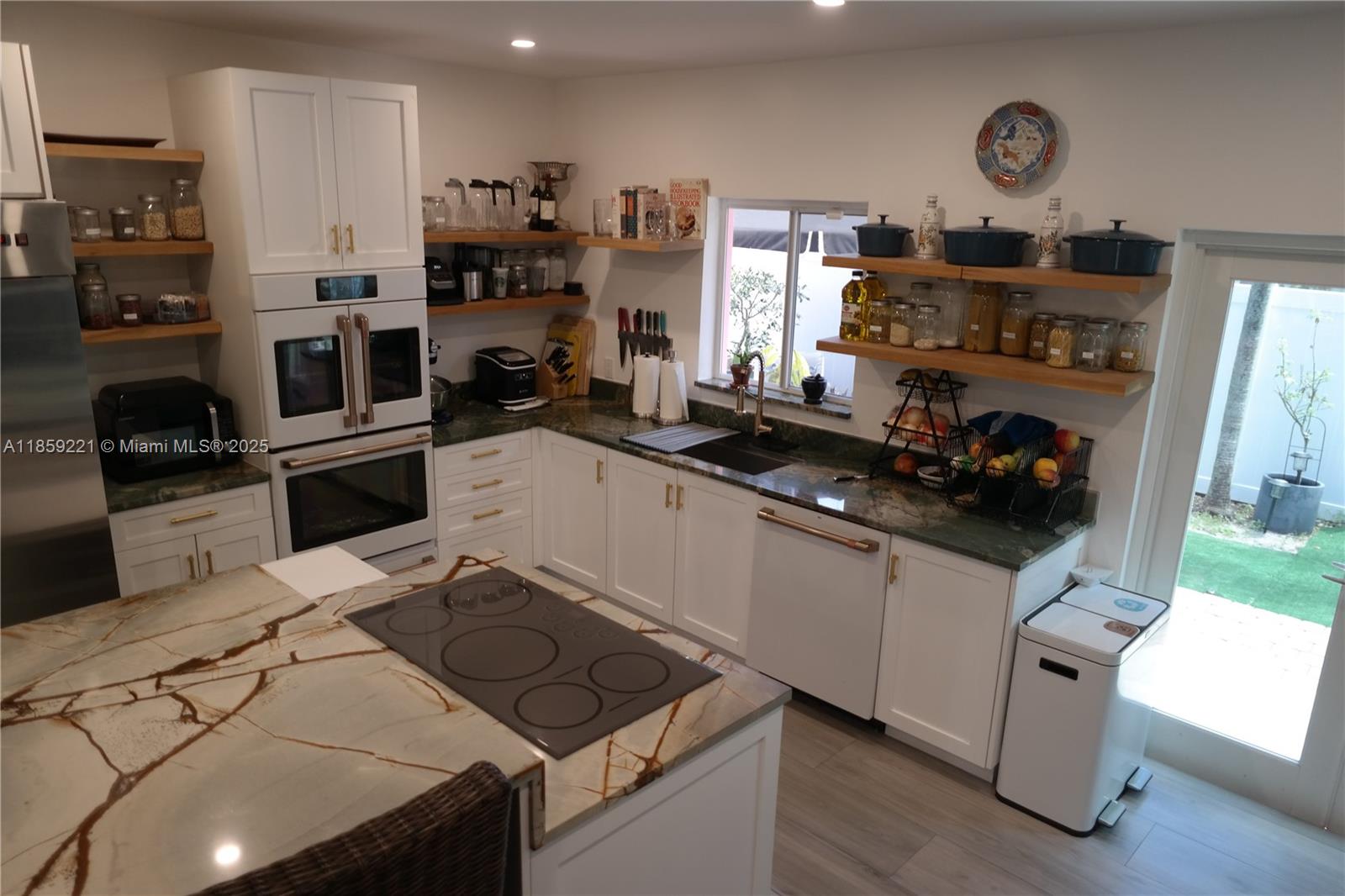 524 Northeast 27th Drive Wilton Manors, FL 33334 - Photo 66 of 95 a kitchen with granite countertop a sink stove and refrigerator