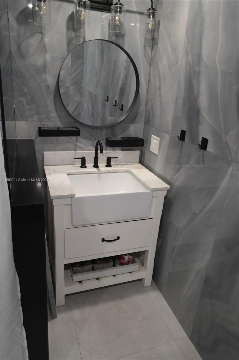 524 Northeast 27th Drive Wilton Manors, FL 33334 - Photo 75 of 95 Bathrooms feature beautiful, modern deep sinks that elevate the space with clean lines and stylish finishes.