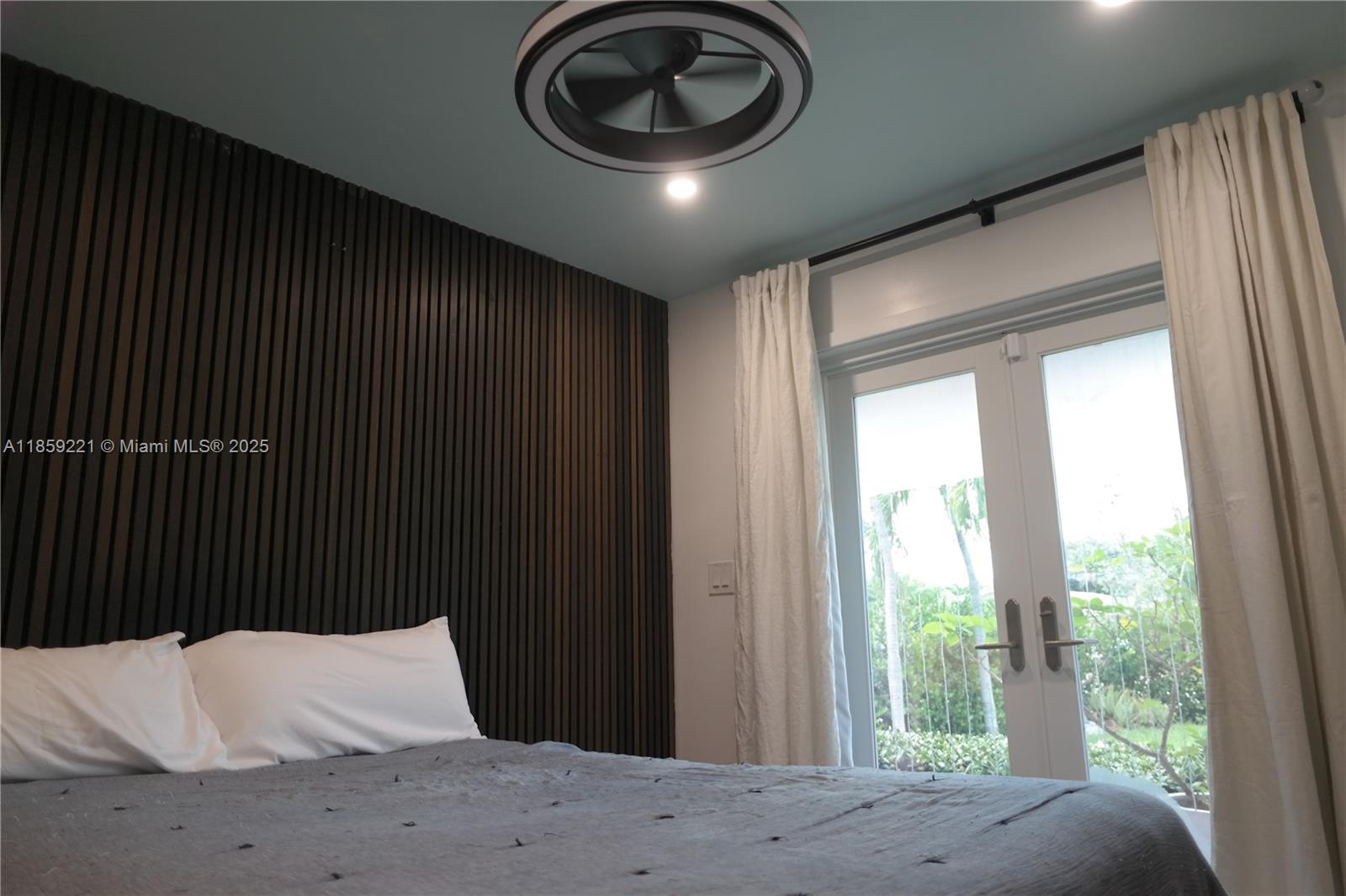 524 Northeast 27th Drive Wilton Manors, FL 33334 - Photo 77 of 95 a bedroom with a bed and a large window