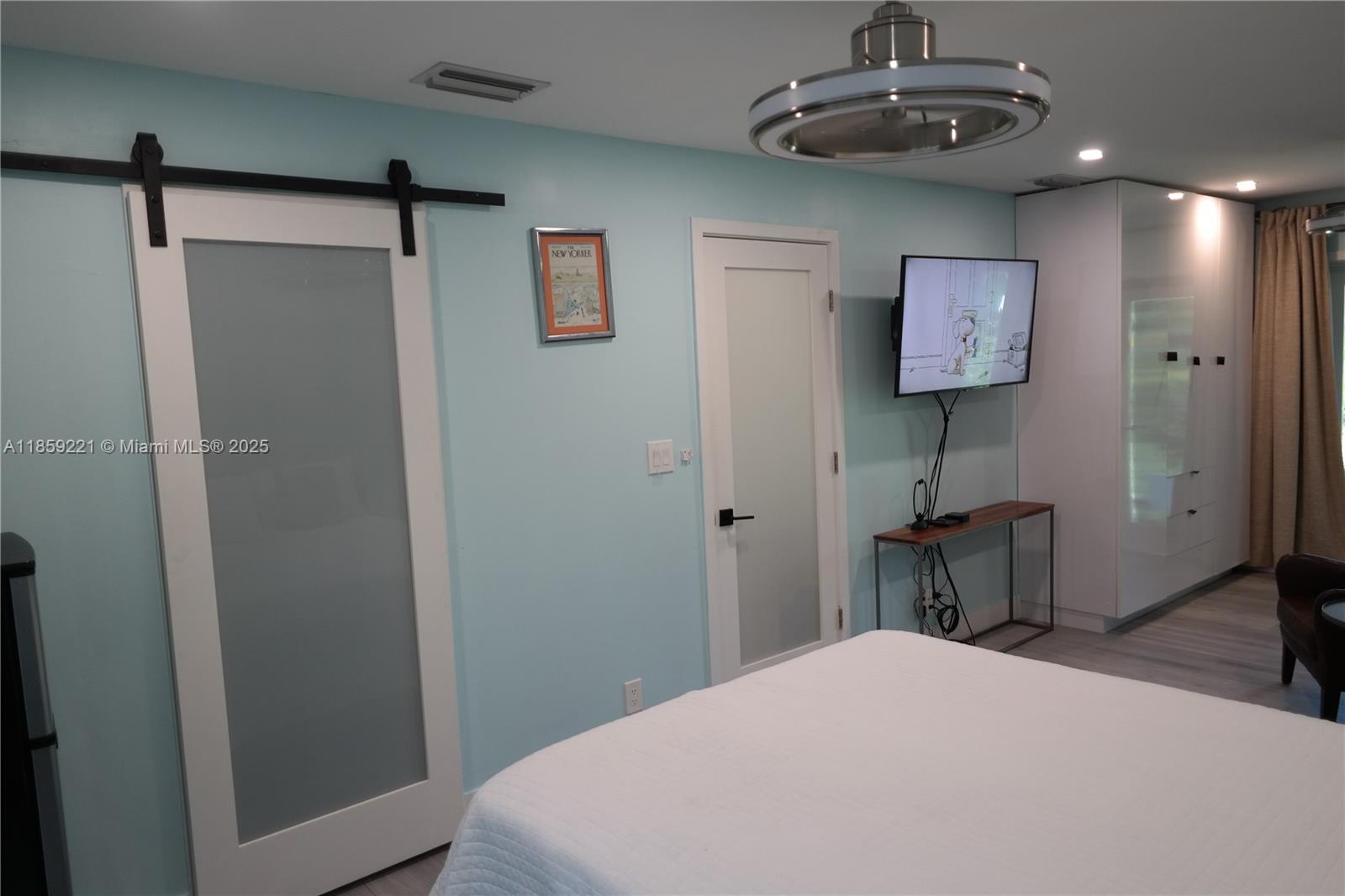 524 Northeast 27th Drive Wilton Manors, FL 33334 - Photo 80 of 95 Oversized bedroom with generous space, dual ceiling fans, and direct access to the bathroom for added convenience