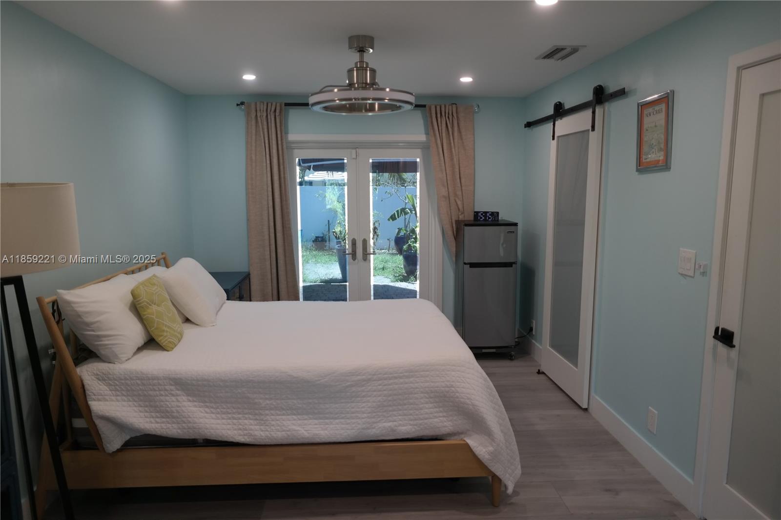 524 Northeast 27th Drive Wilton Manors, FL 33334 - Photo 82 of 95 a bedroom with a large bed and a large window