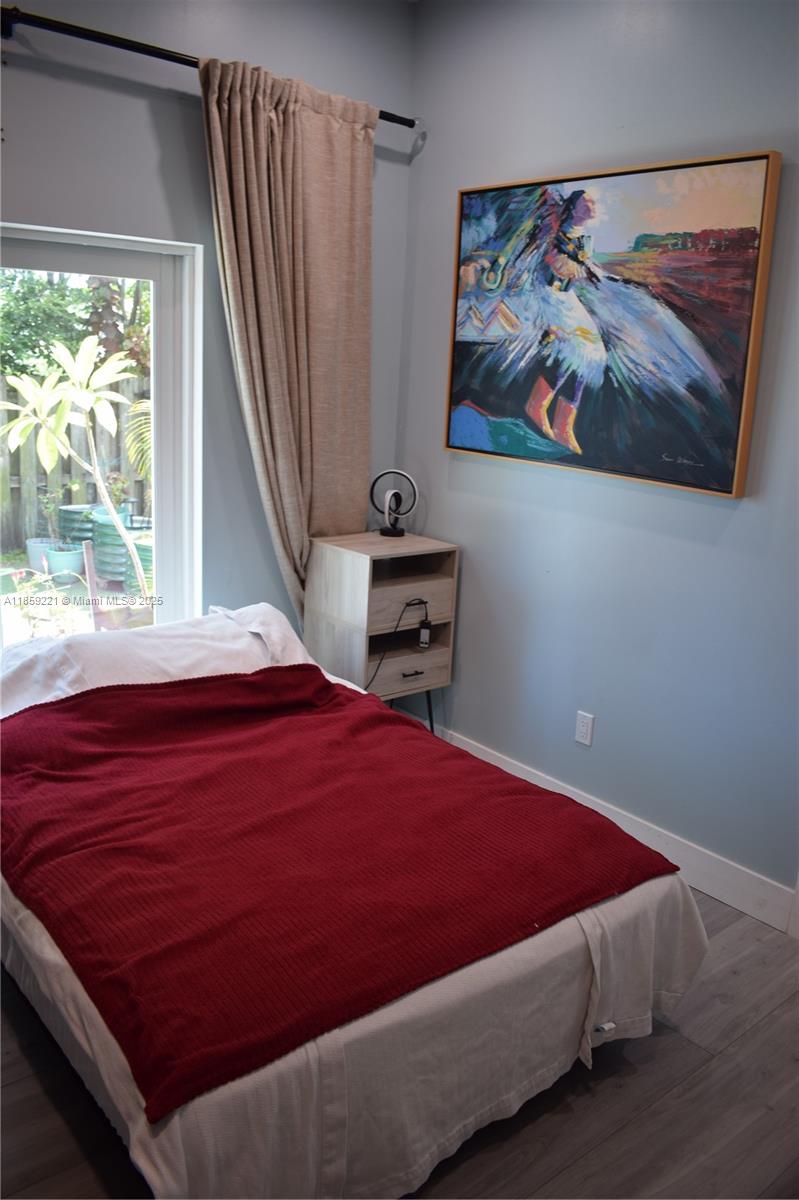 524 Northeast 27th Drive Wilton Manors, FL 33334 - Photo 83 of 95 a room with a bed and a painting on the wall