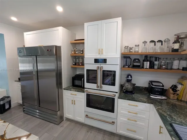 a bedroom with a bed window and a television