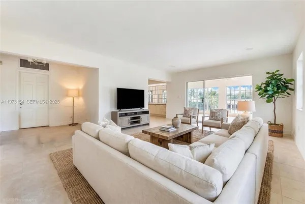 a living room with furniture and a flat screen tv