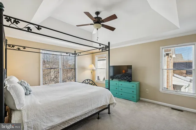 a bedroom with a bed window and dresser