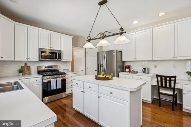 a kitchen with a sink a microwave and cabinets