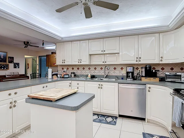 a kitchen with sink cabinets and chair