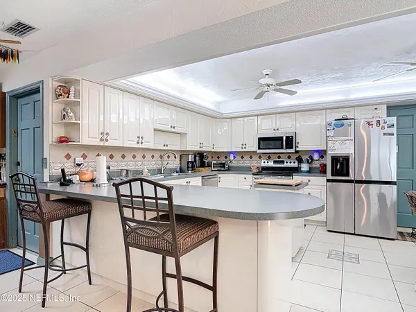 a kitchen with granite countertop a sink stainless steel appliances and cabinets