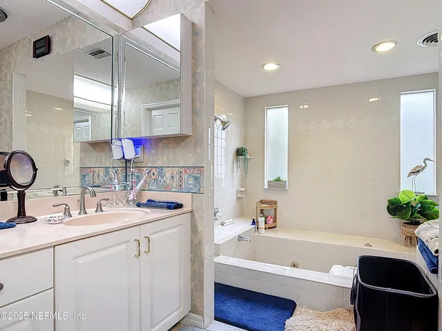 a bathroom with a double vanity sink and mirror