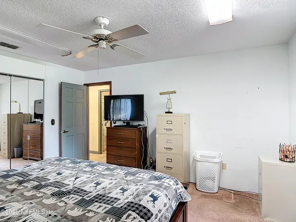 a bedroom with bed and window