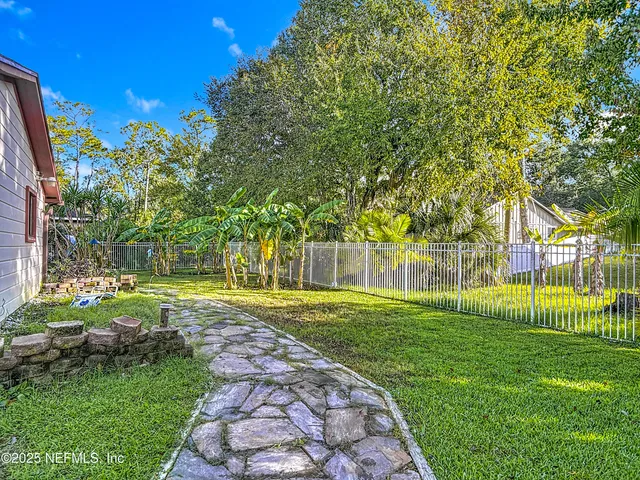 a view of a backyard with a sitting area and slide