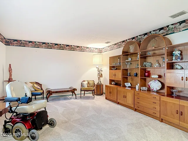 a view of a hallway with dining area