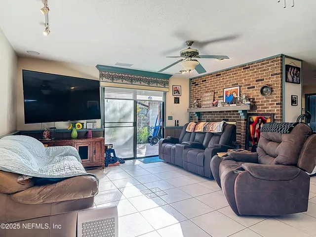 a view of a dining room with furniture and a chandelier