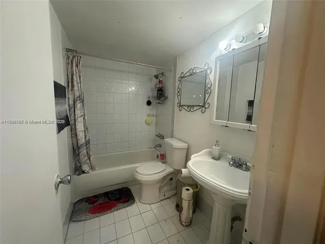 a bathroom with a sink toilet tub and shower