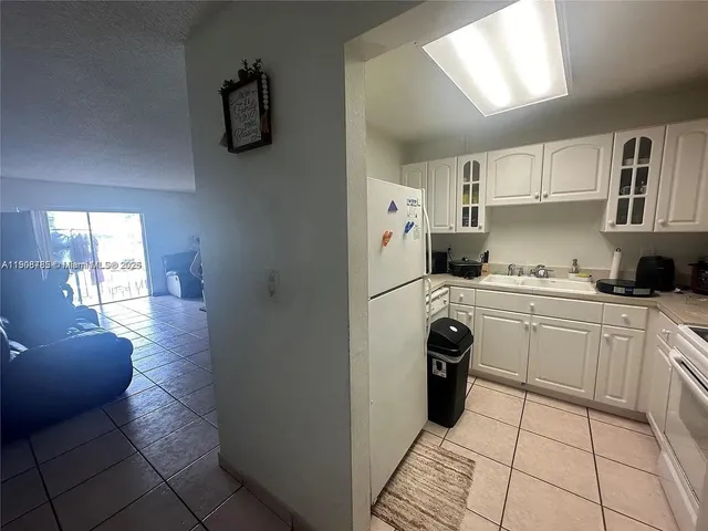 a kitchen with a refrigerator and cabinets