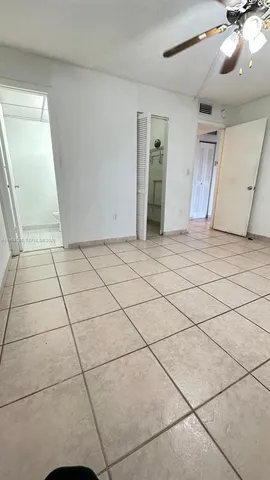 a spacious bathroom with a granite countertop sink a toilet and a mirror
