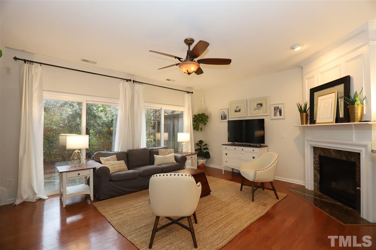 8610 Redcrest Place Raleigh, NC 27617 - Photo 2 of 30 a living room with furniture a fireplace and a flat screen tv