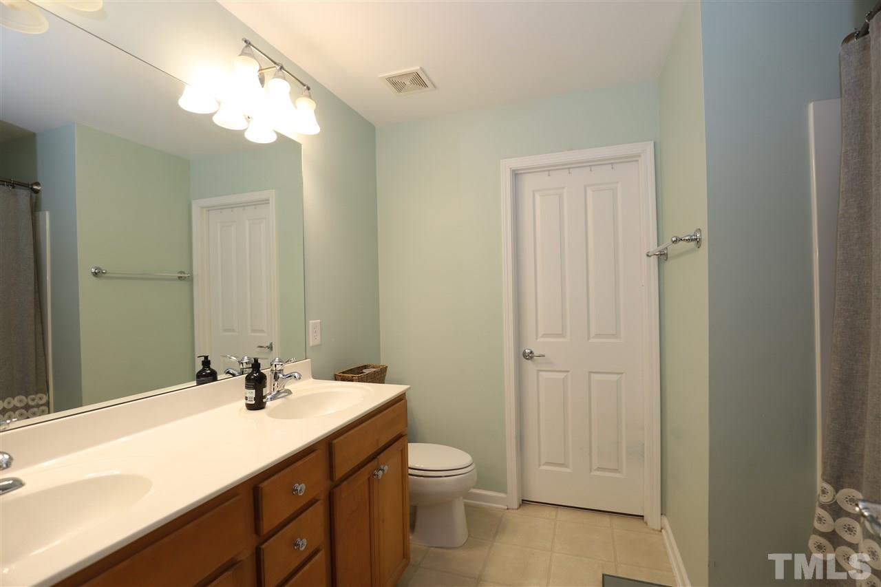 8610 Redcrest Place Raleigh, NC 27617 - Photo 16 of 30 a bathroom with a sink a toilet and shower
