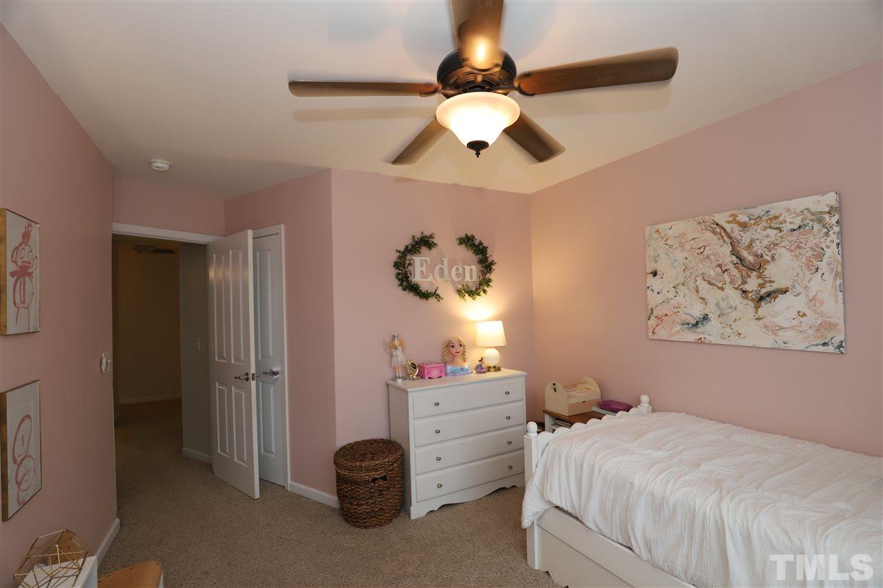 8610 Redcrest Place Raleigh, NC 27617 - Photo 18 of 30 a bedroom that has a bed and a chandelier