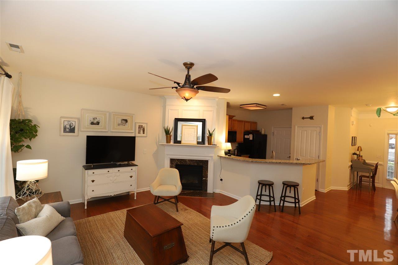 8610 Redcrest Place Raleigh, NC 27617 - Photo 3 of 30 a living room with furniture a fireplace and a flat screen tv
