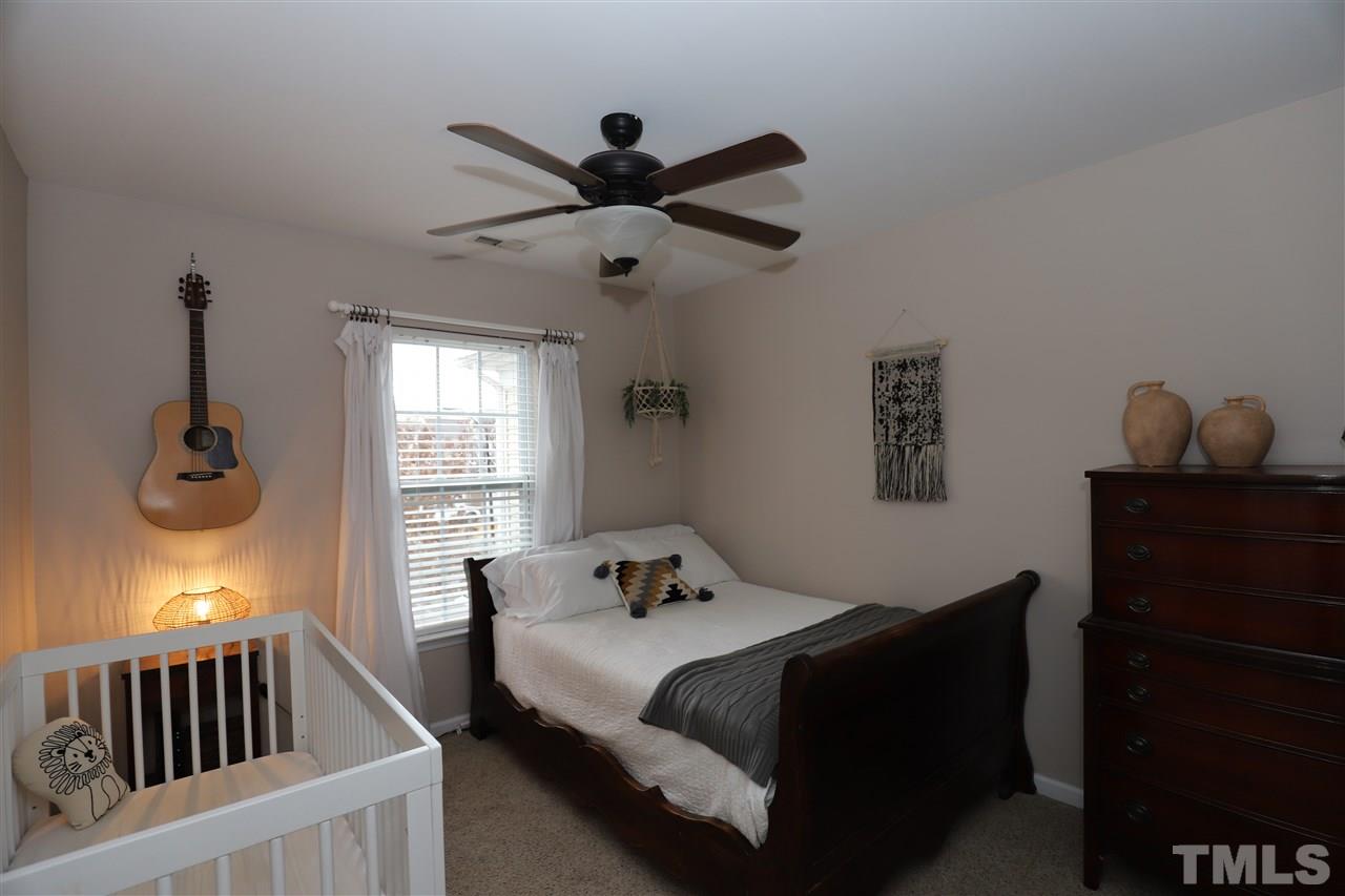 8610 Redcrest Place Raleigh, NC 27617 - Photo 21 of 30 a bedroom with a bed and window