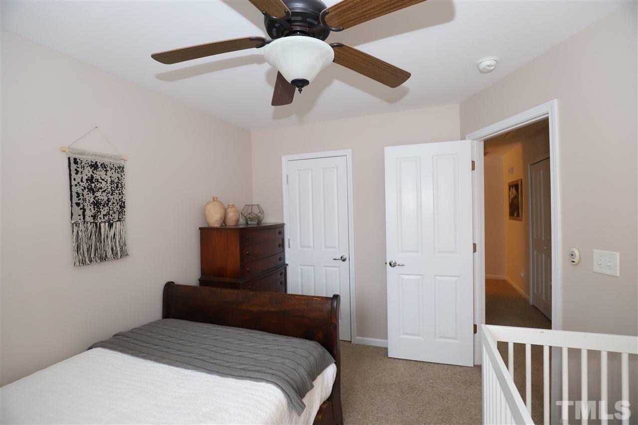 8610 Redcrest Place Raleigh, NC 27617 - Photo 22 of 30 a bedroom with a bed and a painting on the wall
