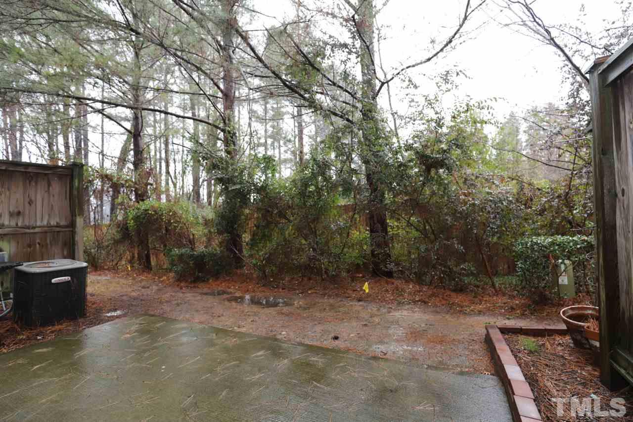 8610 Redcrest Place Raleigh, NC 27617 - Photo 30 of 30 a view of a backyard with potted plants and large trees