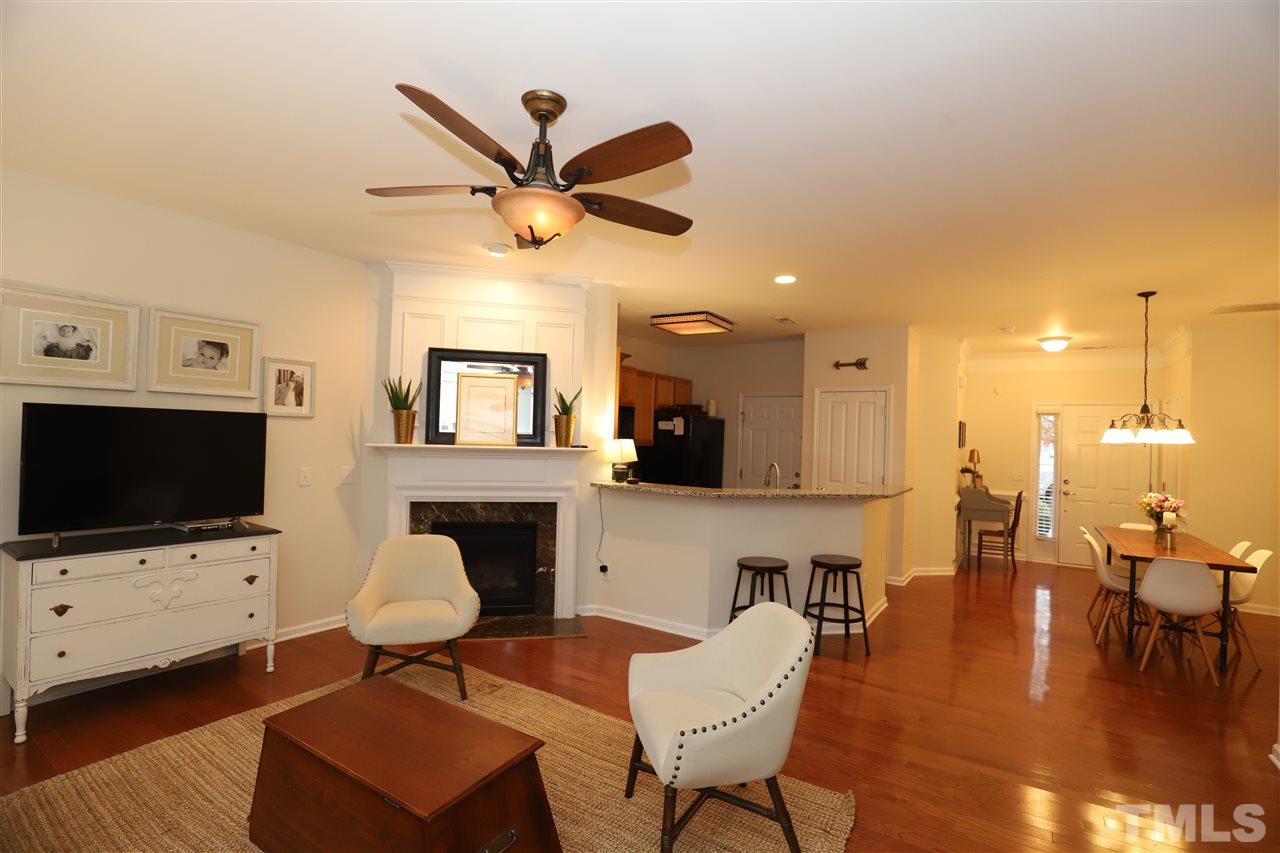 8610 Redcrest Place Raleigh, NC 27617 - Photo 4 of 30 a living room with furniture a fireplace and a flat screen tv