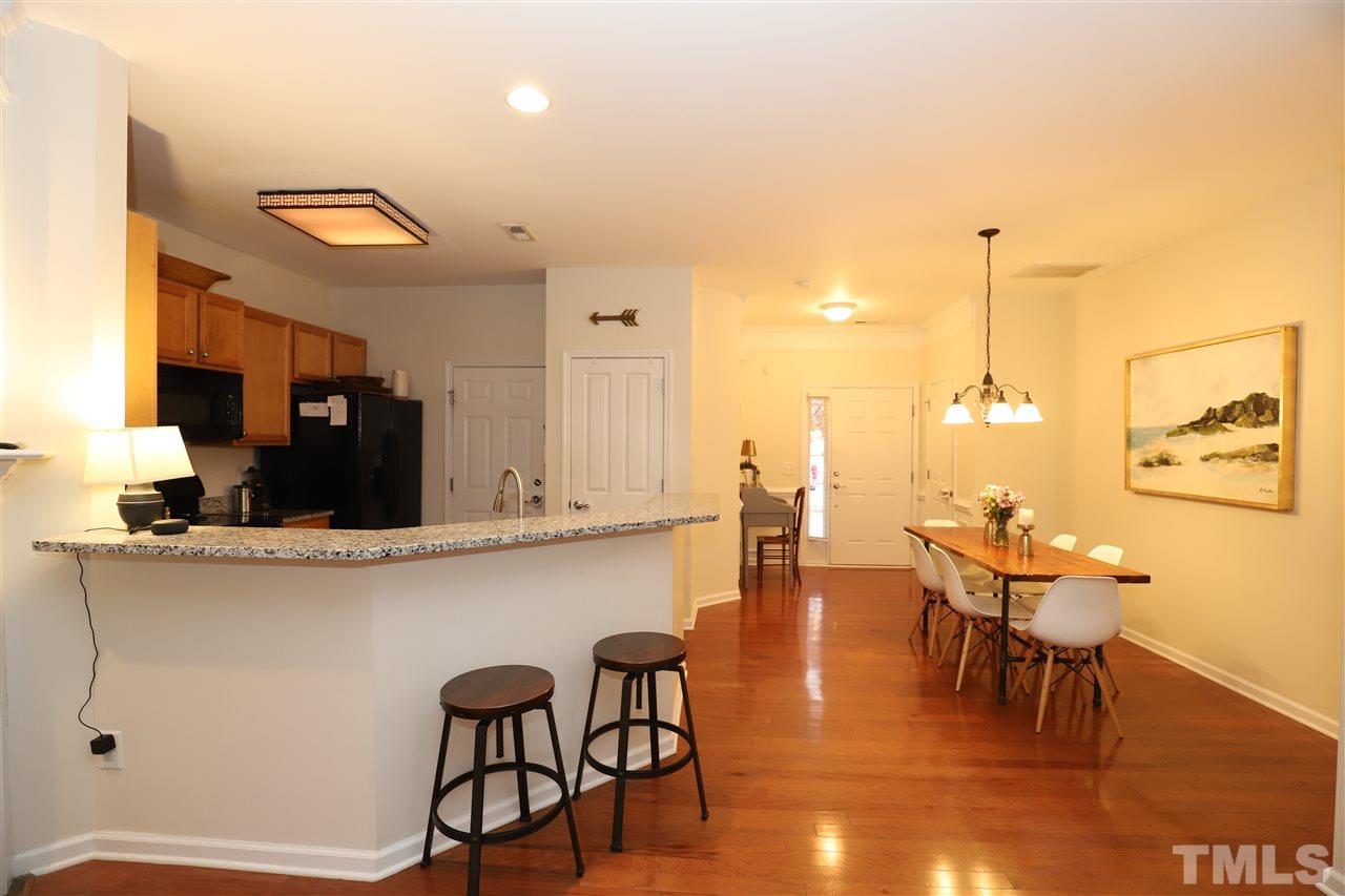8610 Redcrest Place Raleigh, NC 27617 - Photo 5 of 30 a view of a dining room with furniture and wooden floor