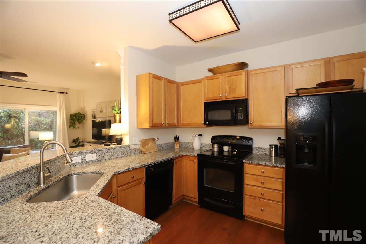8610 Redcrest Place Raleigh, NC 27617 - Photo 7 of 30 a kitchen with a sink stove and refrigerator