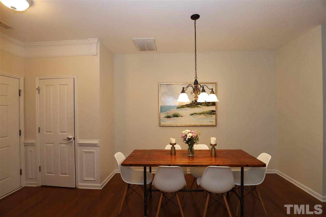 8610 Redcrest Place Raleigh, NC 27617 - Photo 10 of 30 a view of a dining room with furniture and wooden floor