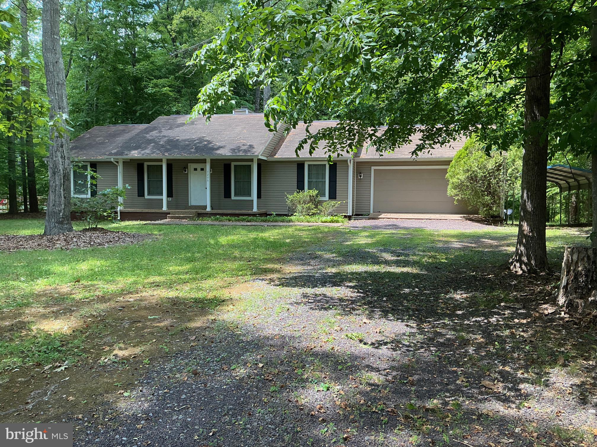 7206 Old Dickersons Road Orange, VA 22960 - Photo 1 of 32 a front view of a house with a garden