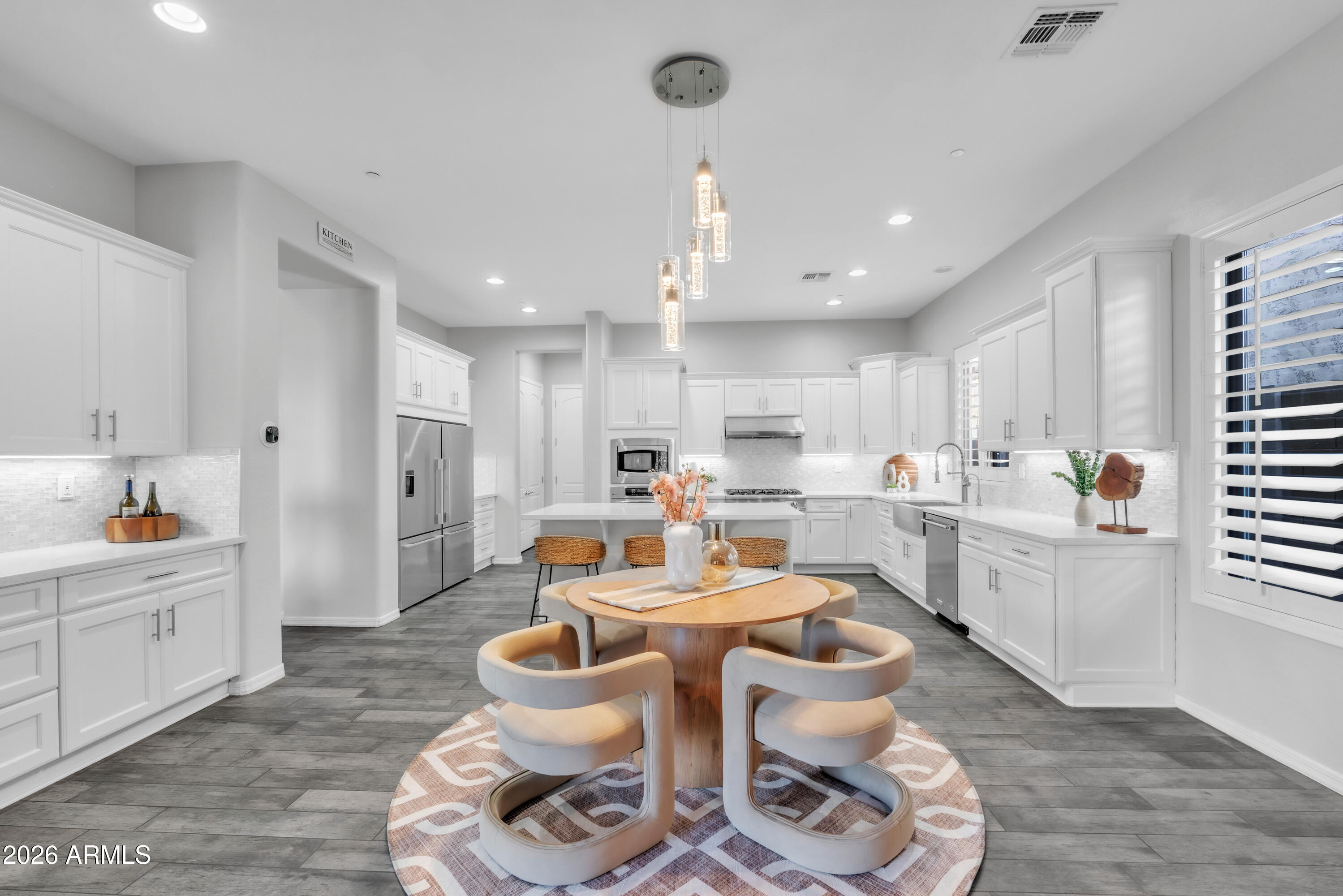 1615 West Red Fox Road Phoenix, AZ 85085 - Photo 14 of 64 a kitchen with white cabinets and white appliances