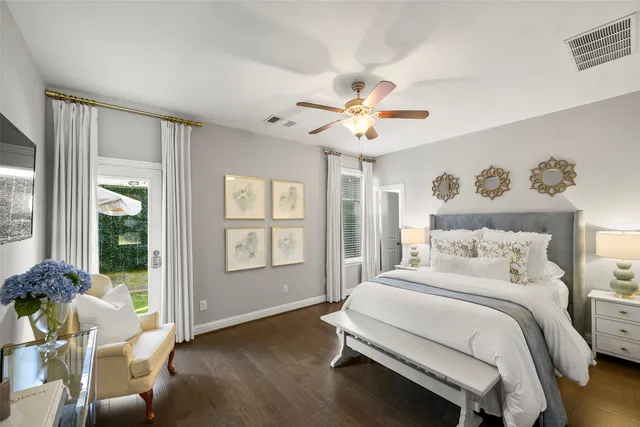 a spacious bedroom with a bed and a chandelier