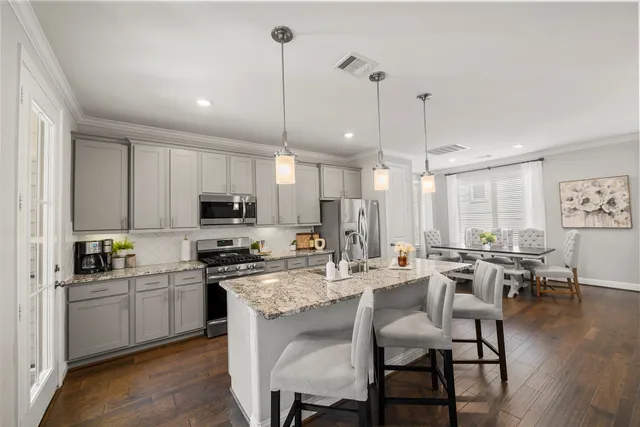 a large kitchen with a table and chairs