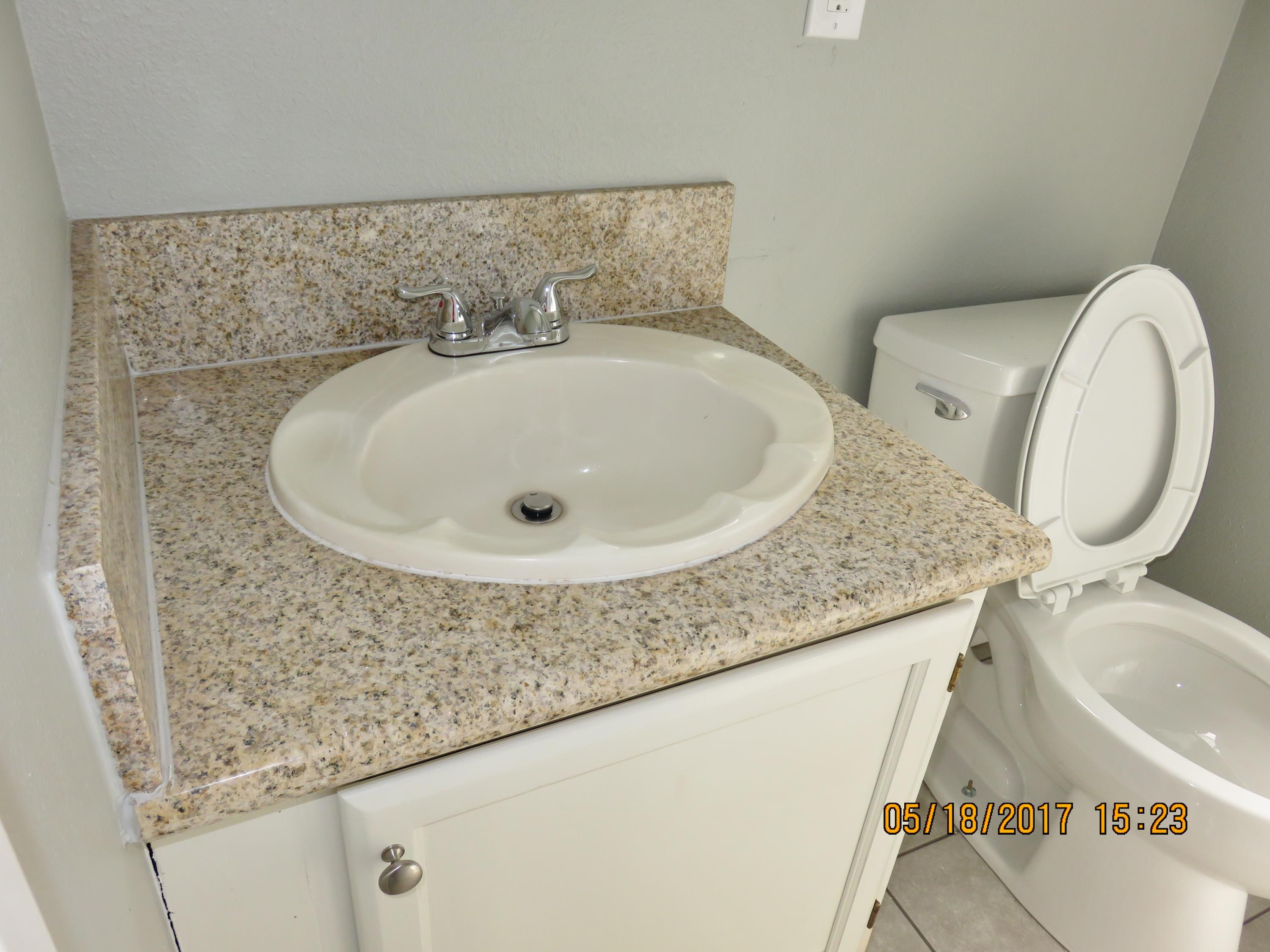 45402 Raysack Avenue Lancaster, CA 93535 - Photo 14 of 15 a bathroom with a granite countertop sink and a mirror
