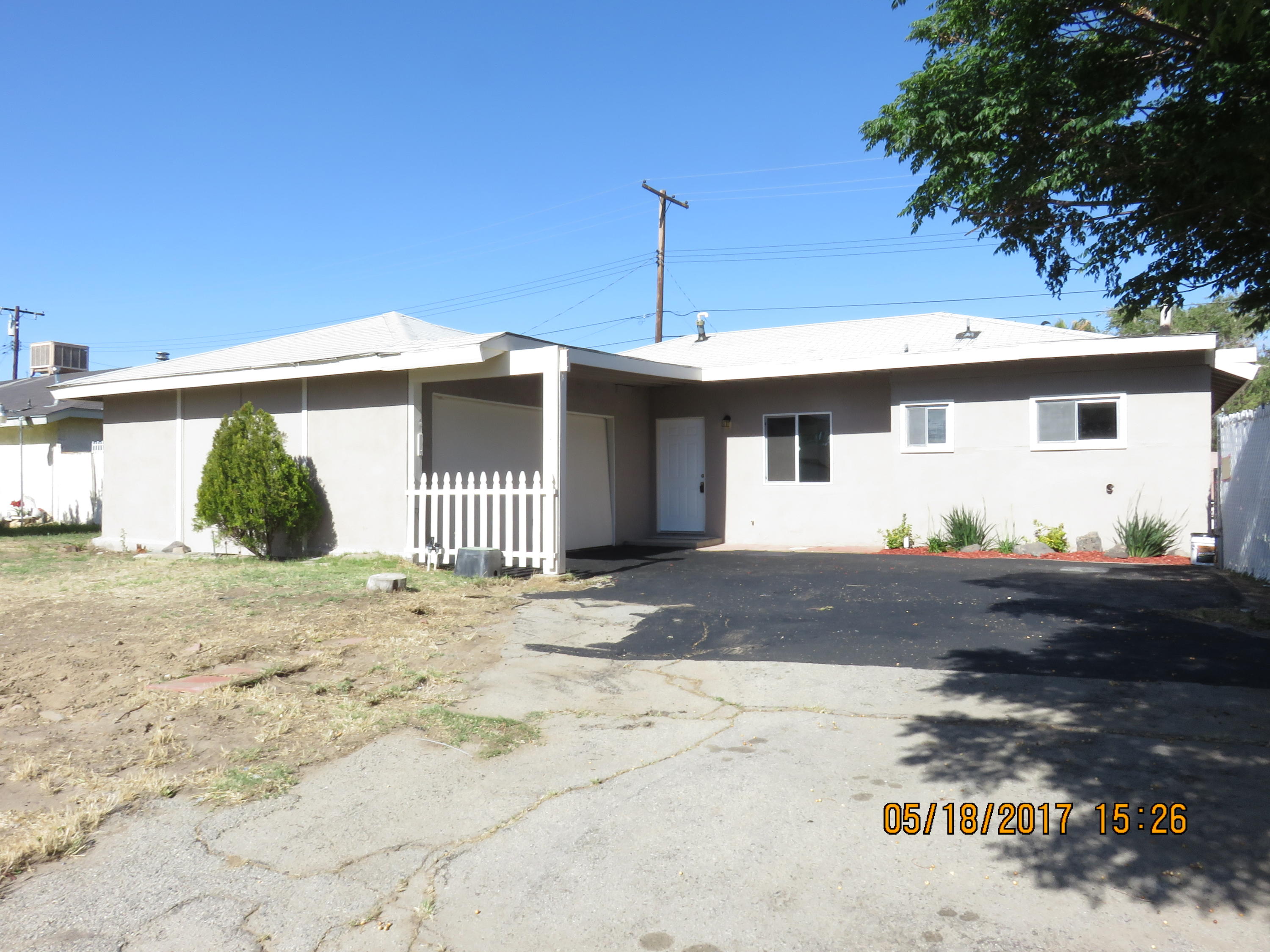 45402 Raysack Avenue Lancaster, CA 93535 - Photo 2 of 15 a front view of a house with garden